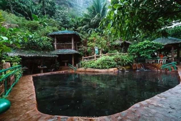 Scenic Valencia Pulangbato Falls with red rock cliffs